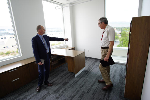 Dean Craig White, left, and Steve Yourstone, a professor at the school, check out the dean’s new office.